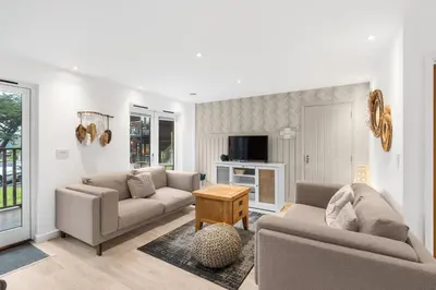 a living room with two couches and a table at Coppercroft Cottage - Stunning Coastal Home, Walk to Beach, Sleeps 4 in Porthtowan