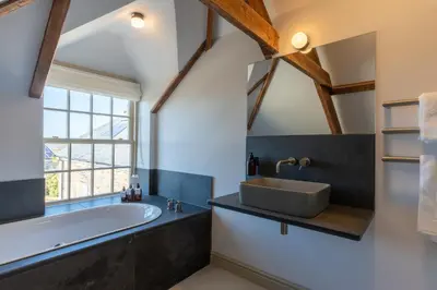a bathroom with a large tub and a sink at Finest Retreats - ARC Padstow in Little Petherick