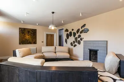 a living room with a couch and a fireplace at Finest Retreats - ARC Padstow in Little Petherick