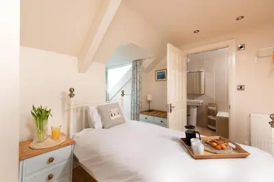 a bedroom with a bed with a tray of fruit on it at Windsor Lookout in St Ives