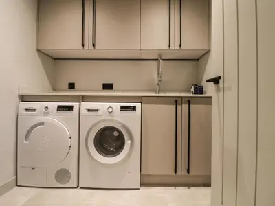 a laundry room with a washer and dryer at The Granary at Boskensoe Barns in Falmouth