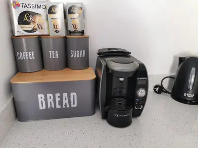 a coffee maker and coffee cups on a counter at Malahne Apartment Port Isaac in Port Isaac