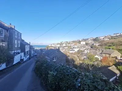 a street in a small town with houses on a hill at Malahne Apartment Port Isaac in Port Isaac