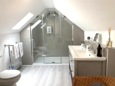 a bathroom with a shower and a toilet and a sink at Superb House in Looe, Near Beach and Bars with Great Views and free access to a nearby Indoor Swimming Pool in Looe