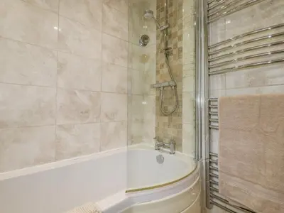 a bathroom with a bath tub and a shower at Merryfield Lodge in Liskeard