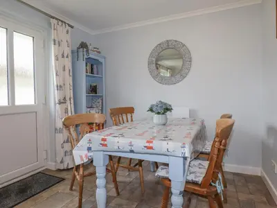 a dining room with a table and chairs at Merryfield Lodge in Liskeard