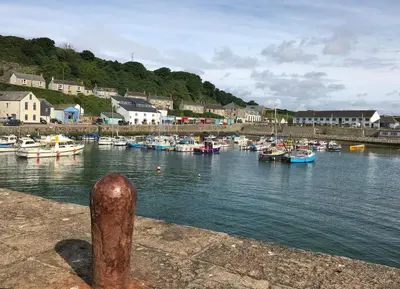 a group of boats are docked in a harbor at Cliff House - a stunning sea view 2 bed apartment in Porthleven in Porthleven