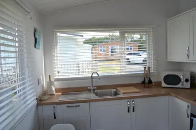 a kitchen with a sink and a window at Holiday Chalet at Gwithian Sands in Cornwall in Gwithian