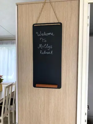 a door with a sign that reads welcome to weights radiator at Mollys Retreat pet friendly three bed caravan with small garden Newquay Bay Resort Quieter area of park in Newquay