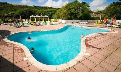 a large swimming pool with people in it at Mollys Retreat pet friendly three bed caravan with small garden Newquay Bay Resort Quieter area of park in Newquay