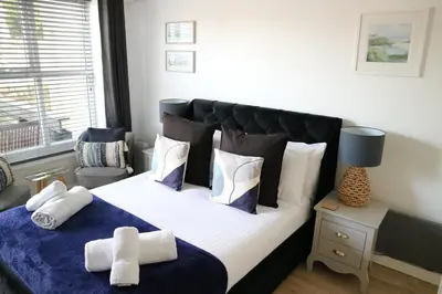 a bedroom with a large bed with pillows at 12a Mault-Ley Studio in St Ives