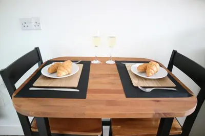 a wooden table with two plates of croissants on it at 12a Mault-Ley Studio in St Ives