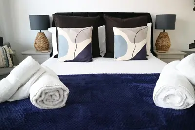 a bedroom with a bed with towels on it at 12a Mault-Ley Studio in St Ives