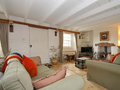 a living room with a couch and a fireplace at Island House in Fowey