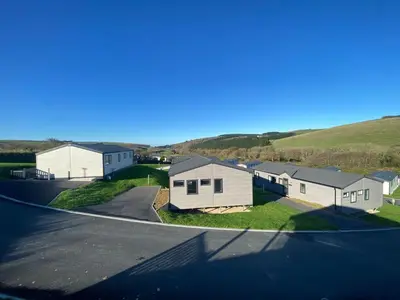 an aerial view of a house with a road at Daphne's Lodge in Mawgan Porth