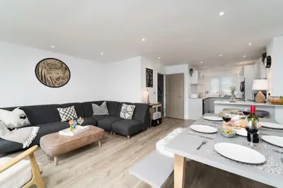 a living room with a couch and a table at Del Mar in St Ives