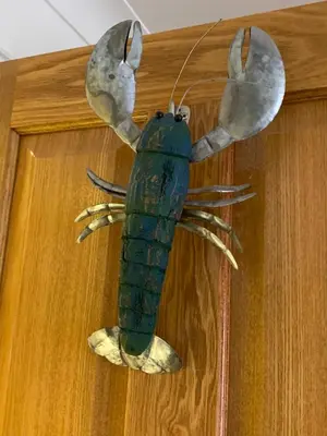 a sculpture of a lobster hanging on a door at 44 Raleigh Close@Padstow in Padstow
