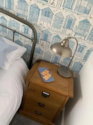 a lamp on a night stand next to a bed at 44 Raleigh Close@Padstow in Padstow