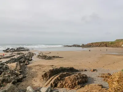 a sandy beach with people walking on the beach at Trelash Cottage in Launceston