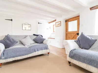 a living room with a couch and a window at Trelash Cottage in Launceston