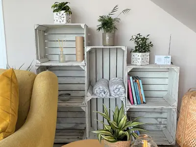 a living room with white furniture and plants at The Neyth in Budock Water