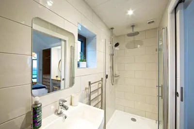 a bathroom with a sink and a mirror at The Neyth in Budock Water