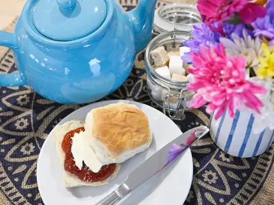 a sandwich on a plate on a table with a knife at Rose View in Newquay