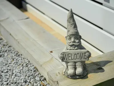 a statue of a wizard holding a welcome sign at Rose View in Newquay