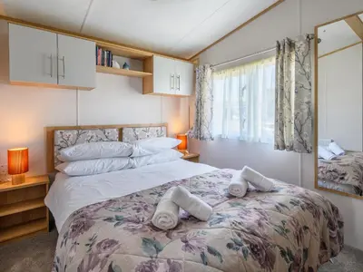 a bedroom with a bed with towels on it at Rose View in Newquay