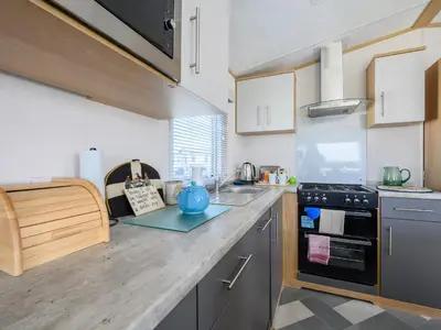 a kitchen with a counter top with a blue pot on a counter at Rose View in Newquay