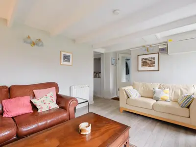 a living room with two leather couches and a table at Finest Retreats - West Cottage at Goldsithney in Perranuthnoe