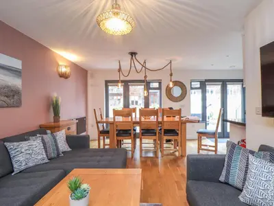 a living room with a couch and a table at Tolcarne in Truro