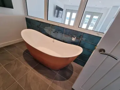 a bath tub in a bathroom with a window at Chy Mor Apartment 1 in St Ives