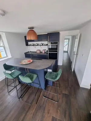 a kitchen with a table and chairs in a room at Chy Mor Apartment 1 in St Ives
