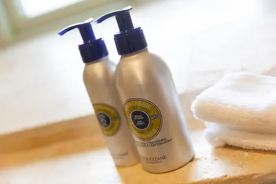 two bottles of shampoo and a stack of towels at The Reading Room in Falmouth