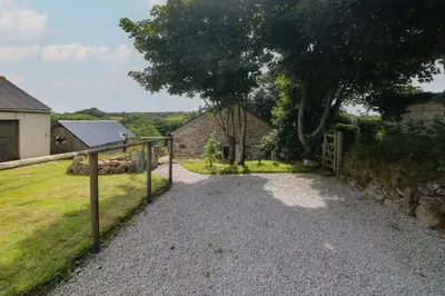 a gravel driveway with a gate in front of a house at The Reading Room in Falmouth