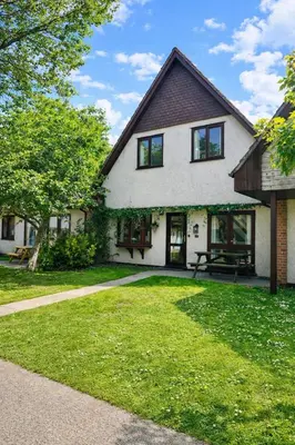 a large white house with a grass yard at Charming & Spacious Holiday Home in Hayle