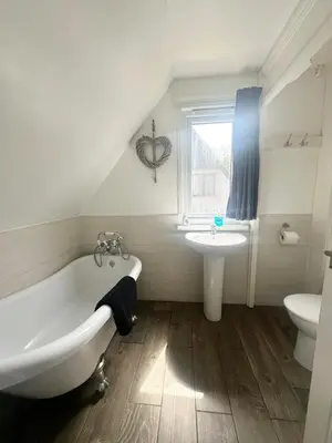 a bathroom with a white tub and a sink at Charming & Spacious Holiday Home in Hayle