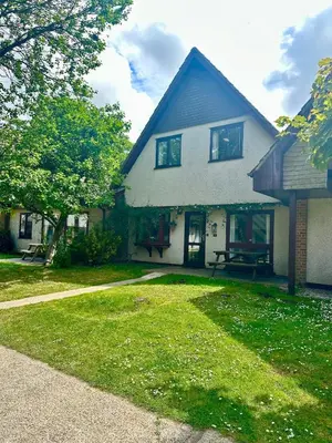 a house with a grass yard in front of it at Charming & Spacious Holiday Home in Hayle