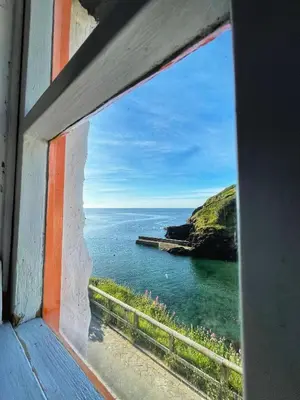 a view of the ocean from a train window at Unique Retreat - 2 bedroom cliff top cottage with large terrace in Portloe