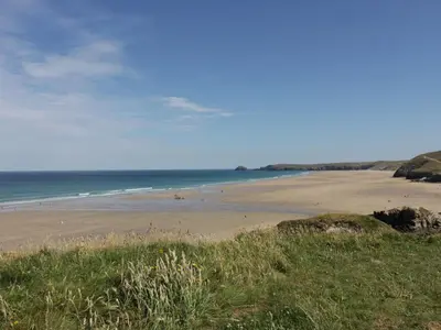 a beach with a group of people on the sand at Perran Pearl B in Perranporth