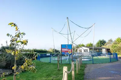 a batting cage with a net in a park at ELITE BLUE LUXURY 3 BEDROOM LODGE NEWQUAY, CORNWALL in Newquay