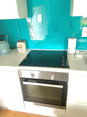 a kitchen with a sink and a oven in it at Idyllic Cornish Cottage, Superking bed, private garden dogs welcome in Truro