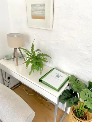 a white desk with a lamp and plants on it at Idyllic Cornish Cottage, Superking bed, private garden dogs welcome in Truro