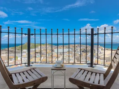 two chairs sitting on a balcony with a view of the ocean at Alfred Wallis in St Ives