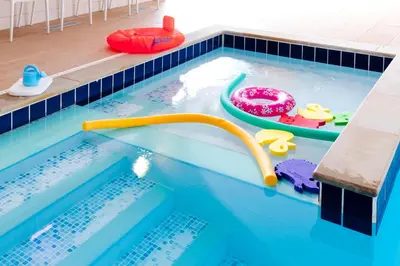 a swimming pool with a water slide in it at PointBreak Sleeps 12 with hot tub-Great celebration house-Dog friendly in Padstow