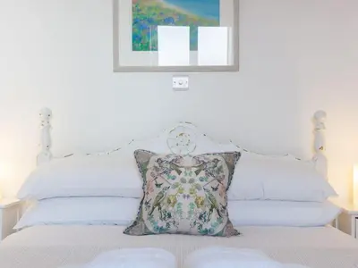 a bedroom with a bed with a pillow on it at Hepworth Apartment in St Ives