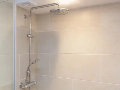 a shower with a glass door in a bathroom at Hepworth Apartment in St Ives