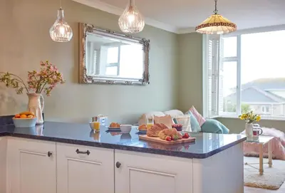a kitchen with a table with fruit on it at Tamarisk House in Newquay