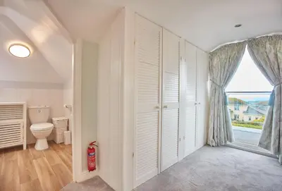a bathroom with a toilet and a window at Tamarisk House in Newquay